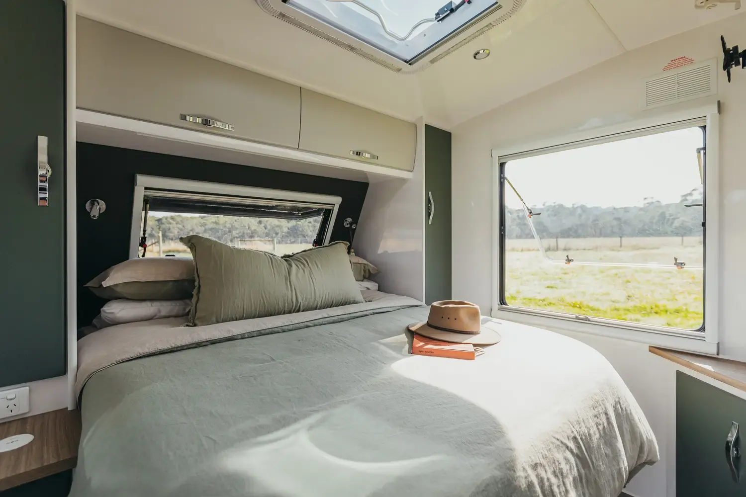 Touring caravan interior with bed and skylight
