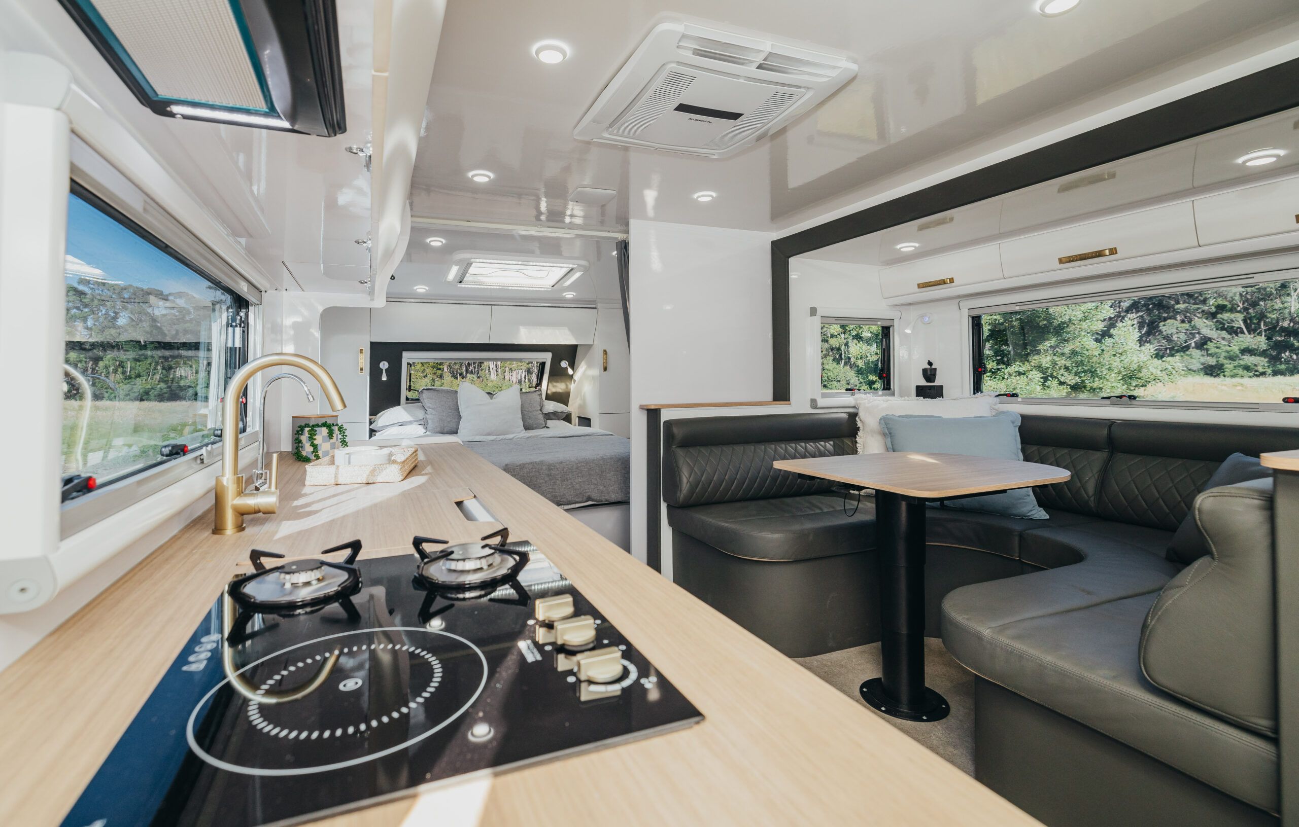 Luxury caravan interior with kitchen, lounge, and bedroom